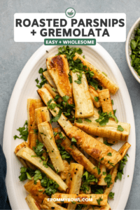 roasted parsnips topped with gremolata on oval white serving dish