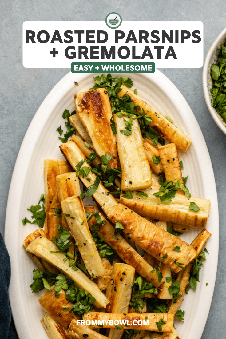 roasted parsnips topped with gremolata on oval white serving dish