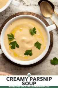 parsnip soup in white bowl topped with parsley and olive oil