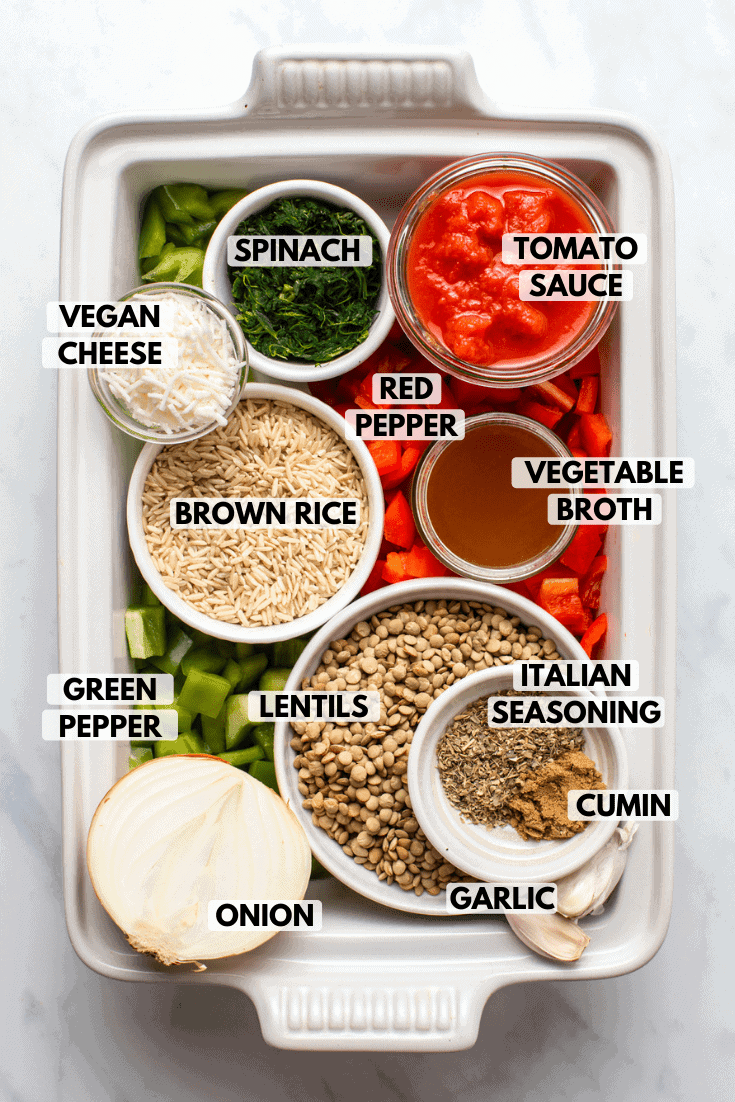 Ingredients for stuffed pepper casserole arranged in small bowls inside of casserole dish