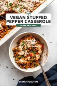 Stuffed Pepper casserole in white bowl topped with melty vegan cheese and parsley