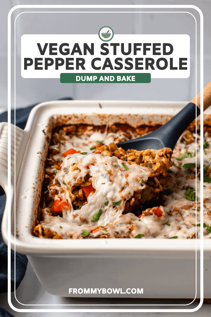 Spoon scooping serving of stuffed pepper casserole out of white baking dish