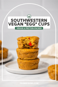 Stack of vegan egg cups with bite taken out of top cup on white plate