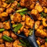 Vegan cashew chicken with cashews and green onions in sauce