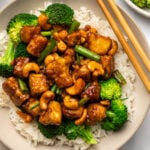 vegan cashew chicken in bowl served over steamed broccoli and white rice