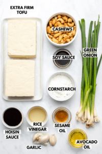 ingredients for cashew "chicken" in small bowls on kitchen countertop