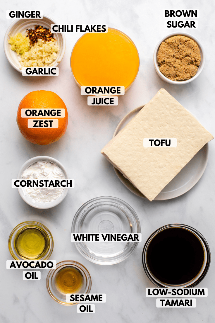 Ingredients for orange tofu arranged on marble countertop