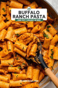 buffalo ranch pasta in saute pan with spoon scooping out some pasta