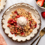 Strawberry rhubarb crisp topped with vanilla ice cream