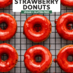 glazed strawberry donuts on a cooling rack
