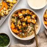 bowl of ranch tofu with roasted vegetables and rice topped with tahini sauce