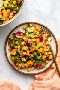 peach and chickpea salad on plate with gold fork