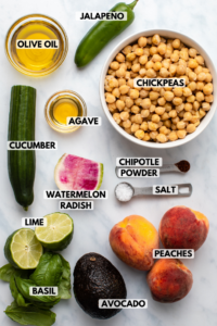 ingredients for chickpea salad in small bowls on kitchen countertop