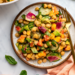 peach and chickpea salad on plate with gold fork