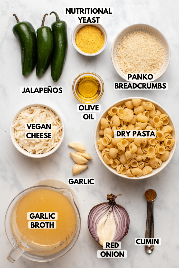ingredients for vegan jalapeño mac and cheese in small white bowls on marble background