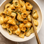 bowl of vegan jalapeño mac and cheese with garlic breadcrumbs on marble countertop