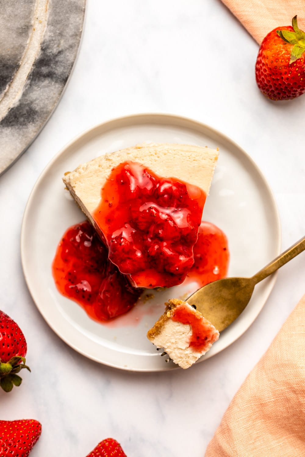 Slice of vegan cheesecake topped with strawberry compote