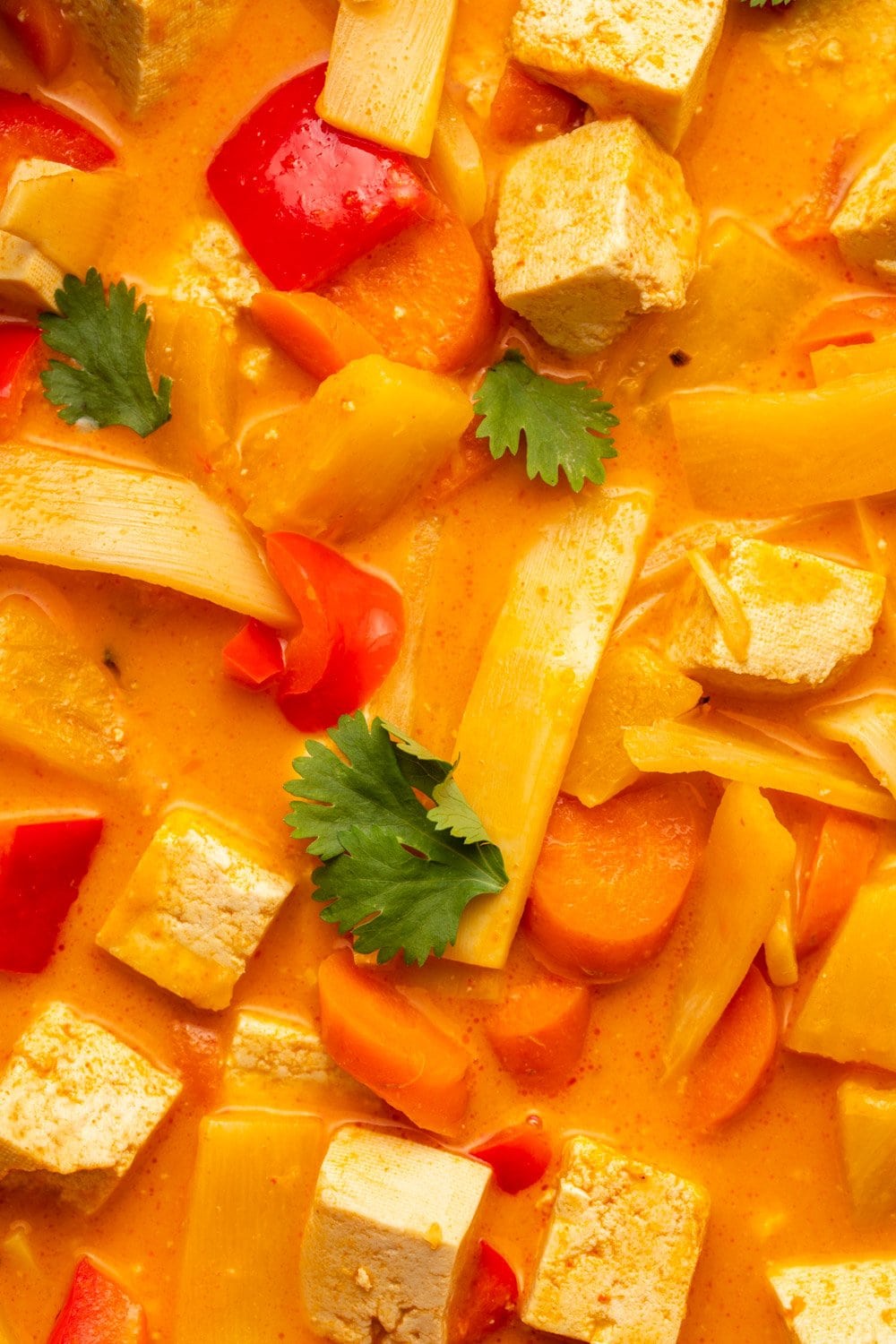 close-up of pineapple curry with tofu and red bell peppers