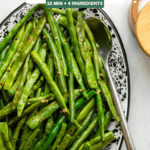 cooked green beans in speckled white serving tray