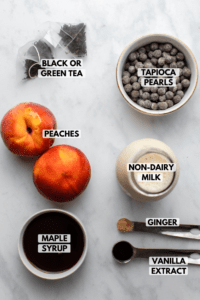 ingredients for bubble tea in small bowls on marble background
