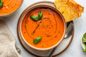 roasted tomato soup topped with fresh basil and olive oil