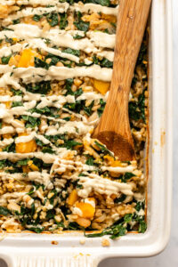 cooked butternut squash casserole topped with rosemary garlic cashew cream