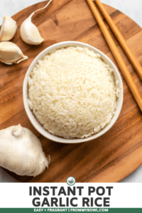bowl of cooked white rice with garlic on wooden cutting board