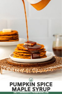 hand pouring maple syrup on stack of pancakes