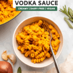 pumpkin vodka sauce with pasta in small white bowl with fork
