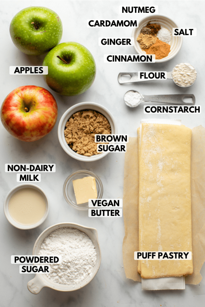 ingredients for apple turnovers arranged on marble countertop