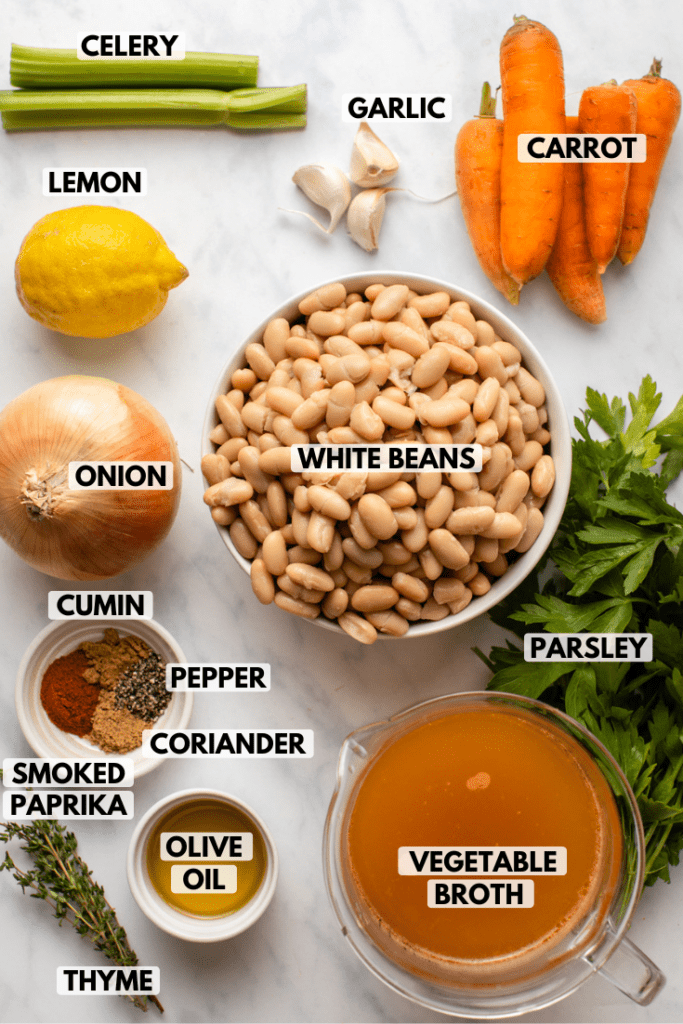 ingredients for vegan white bean stew arranged on kitchen countertop