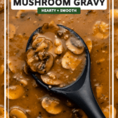 vegan mushroom gravy in large pan with serving spoon