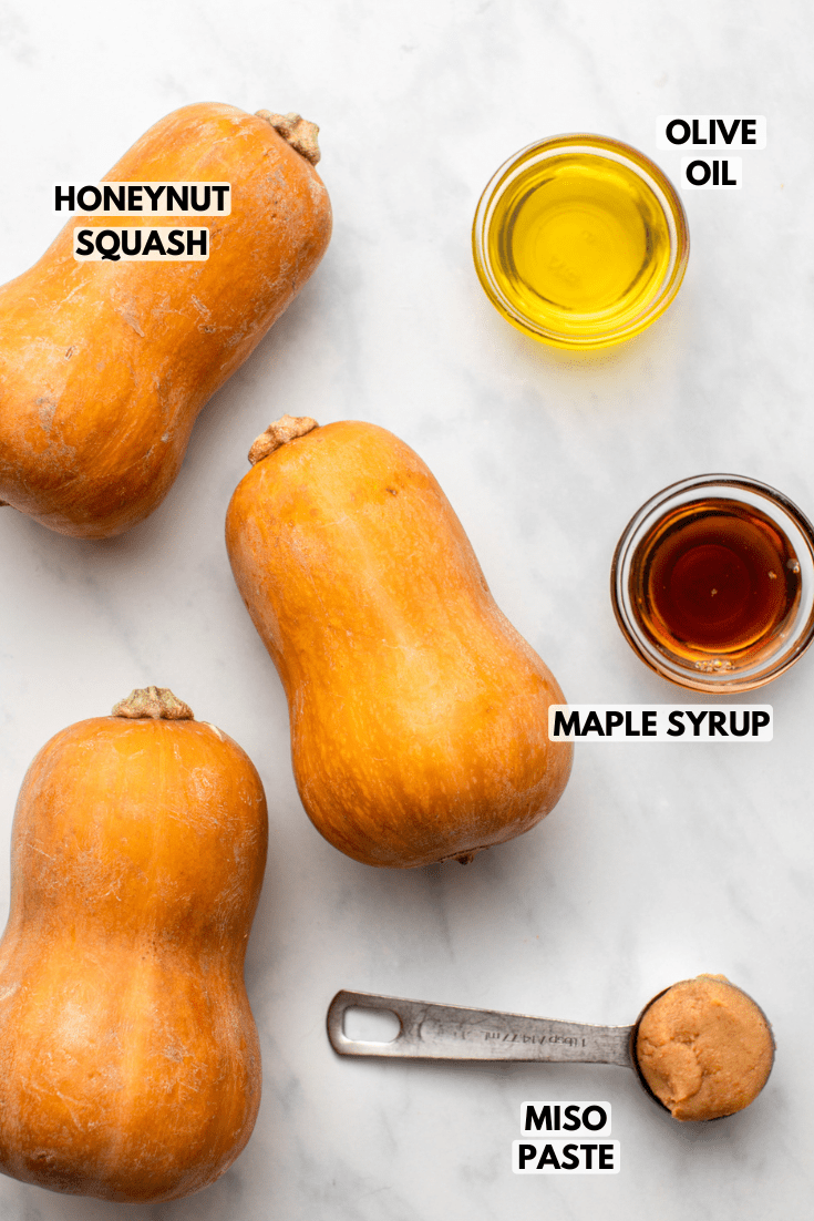 ingredients for the roasted honeynut squash in small bowls on a kitchen countertop