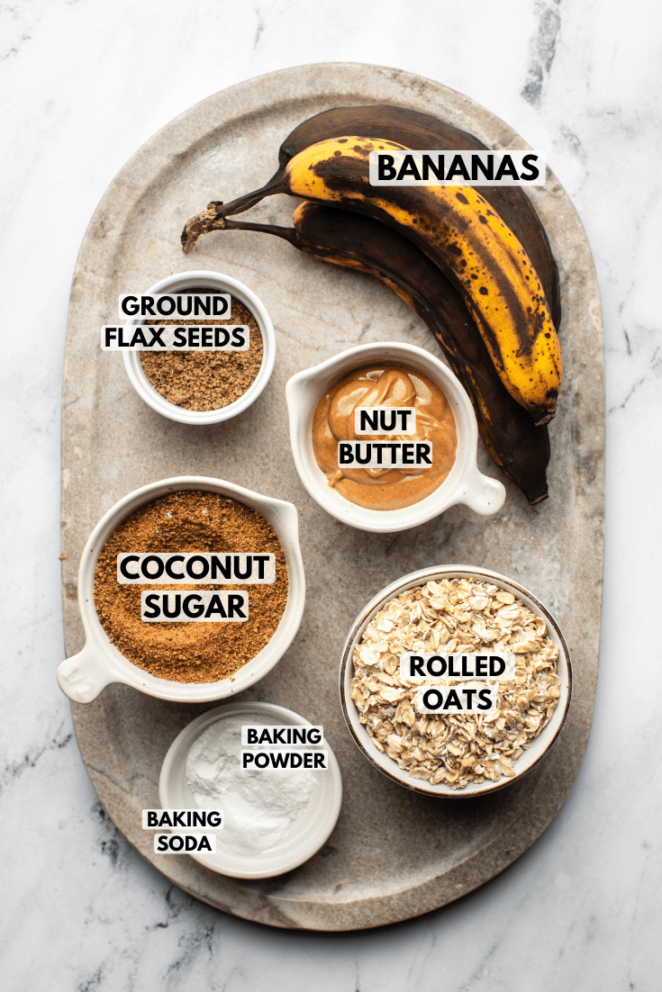ingredients for the vegan banana bread served in measurement cups and laid out on a kitchen countertop