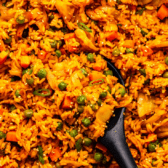 Kimchi fried rice in large pan with wooden spoon