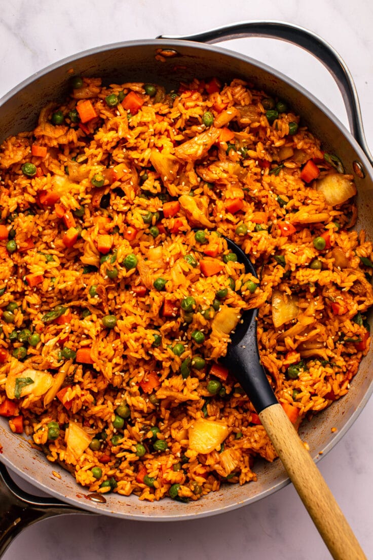 Kimchi Fried Rice in large pan with wooden serving spoon