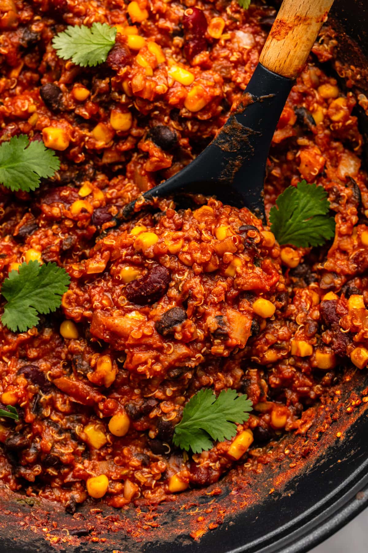 a zoomed in image of slow cooker quinoa chili topped with cilantro