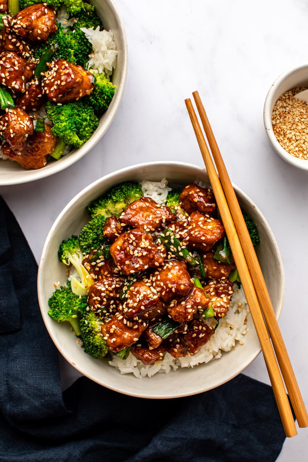 teriyaki tofu served in a white bowl with rice and broccoli