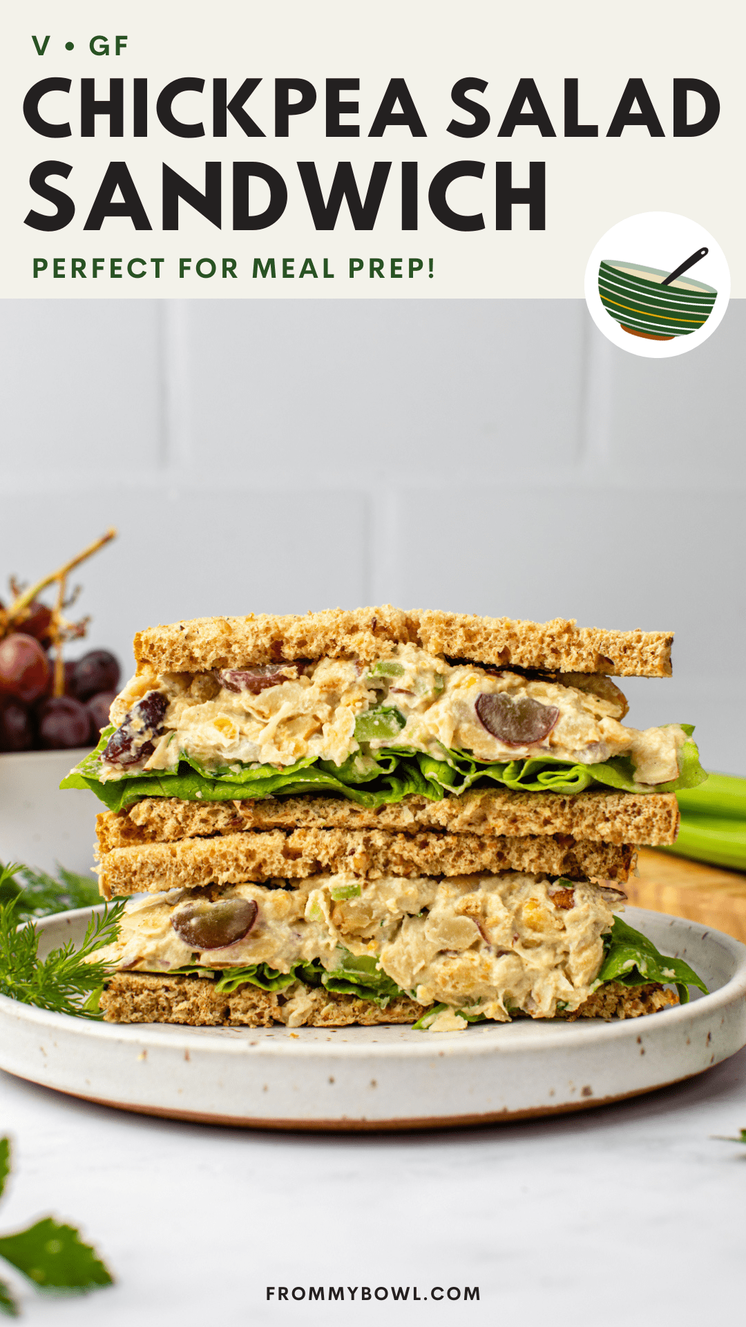 vegan chickpea salad sandwich cut in half and stacked on white plate