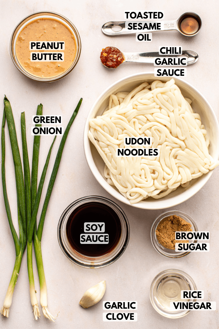ingredients for peanut noodles laid out on a kitchen countertop in various sizes of bowls