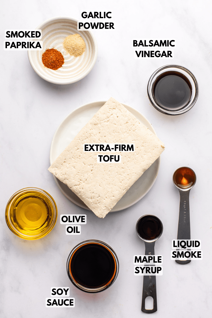 ingredients for smoky marinated tofu laid out on a marble kitchen countertop
