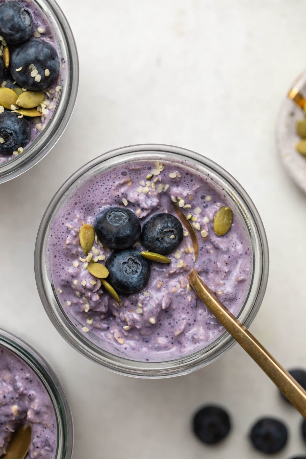blueberry overnight oats served in a jar topped with fresh blueberries