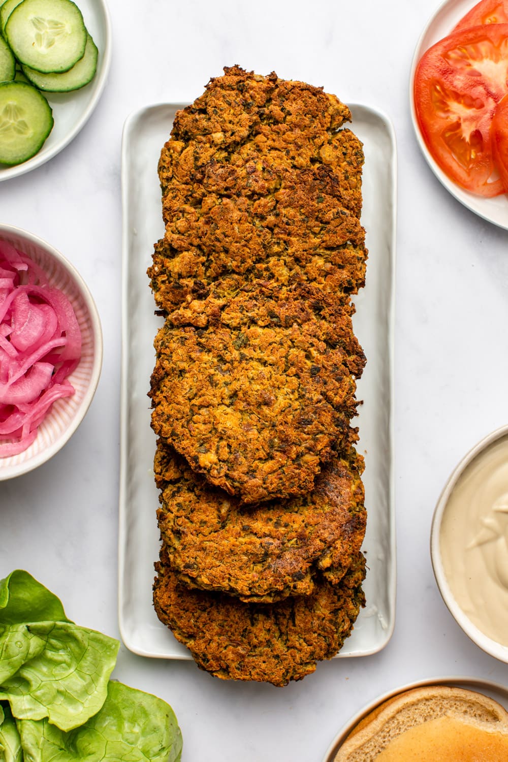 baked falafel patties served on top of each other on a rectangular plate