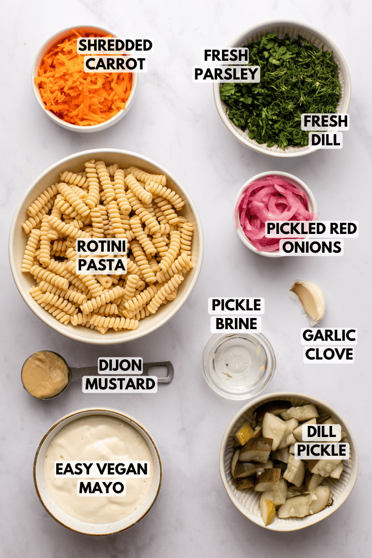 ingredients for dill pickle pasta salad laid out on a kitchen countertop