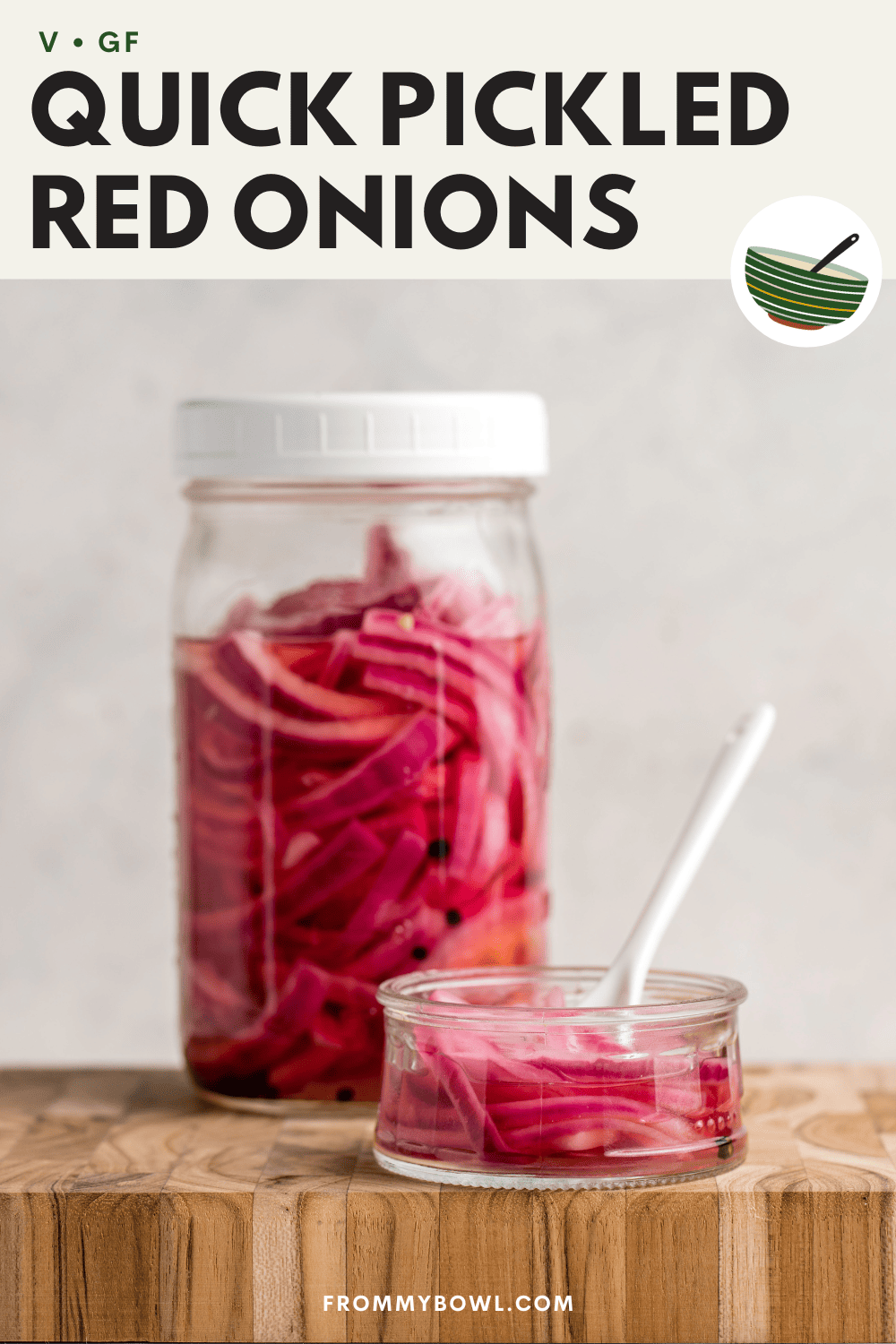 pickled red onions served in a small glass plate with a glass jar of pickled red onions in the background