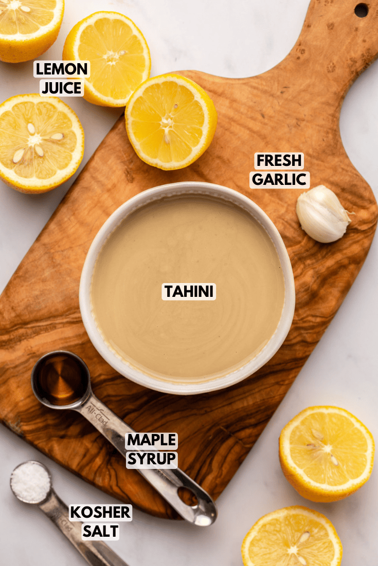 ingredients for tahini dressing laid out on a cutting board