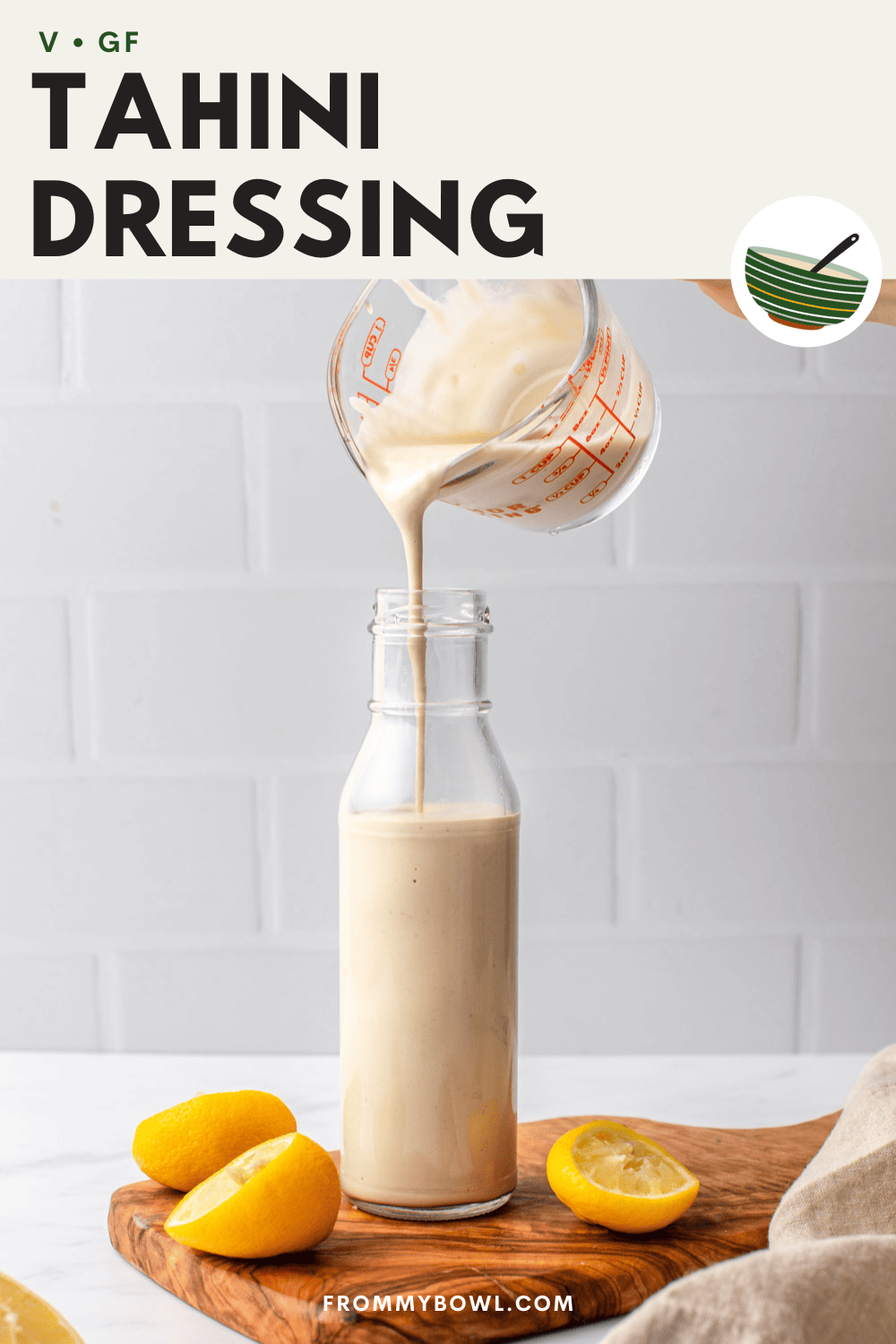 tahini dressing being poured in a bottle
