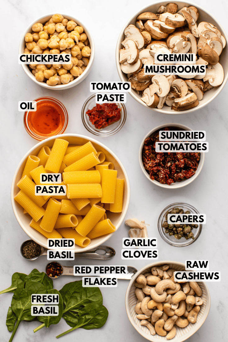 ingredients for pasta laid out on a marble kitchen countertop