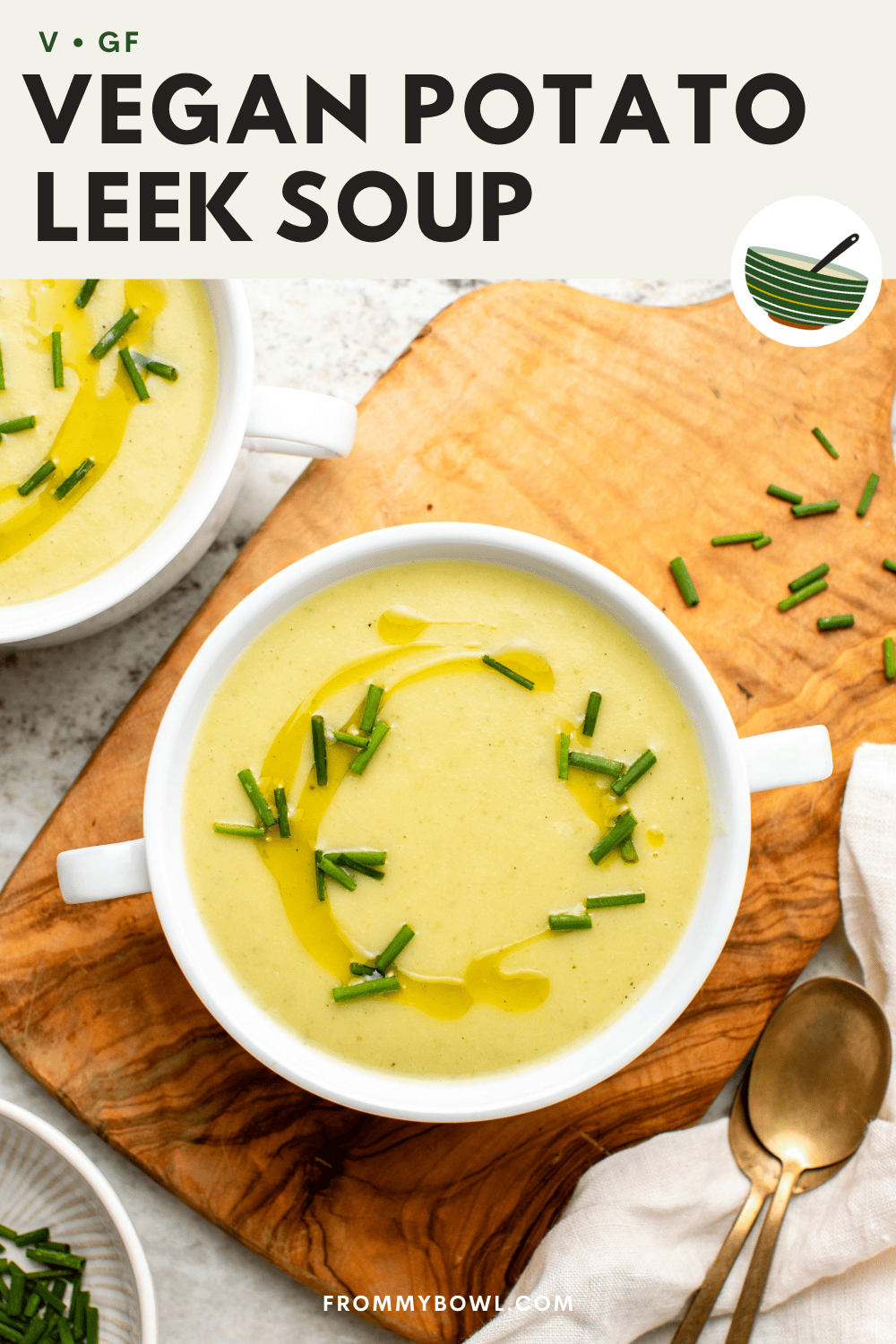 Two bowls of potato leek soup topped with olive oil and chives