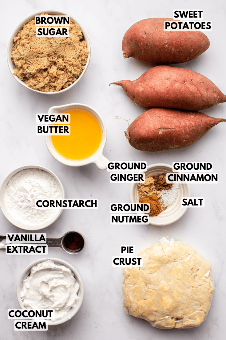 ingredients for sweet potato pie laid out on a marble kitchen countertop